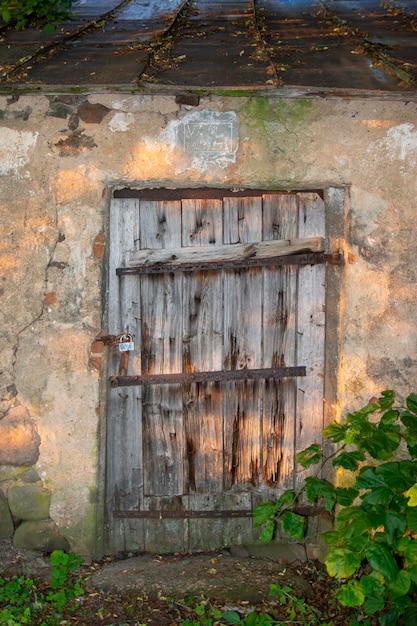 Old wooden door of an outbuilding under lock and key