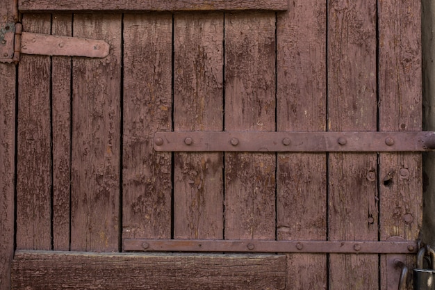 Old wooden door with peeling and cracked paint.