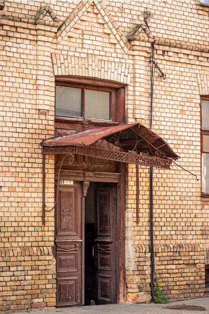 An old wooden door with a visor in a city house