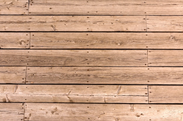 Old wooden floor of crooked boards background. Natural wood texture.