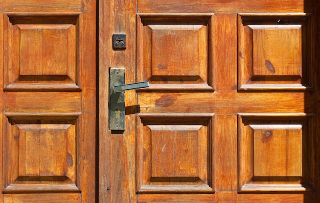 Old wooden front door with a handle Dilapidated entrance doors made of wood