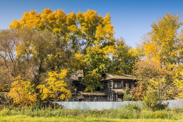 Old wooden house on autumn sunny day