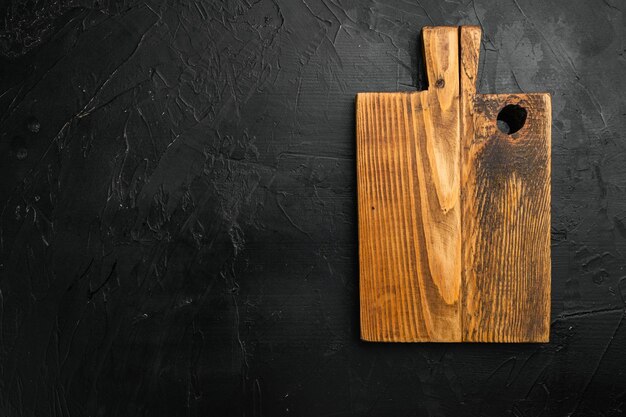 Old wooden kitchen board set, top view flat lay , with copy space for text or food, on black background