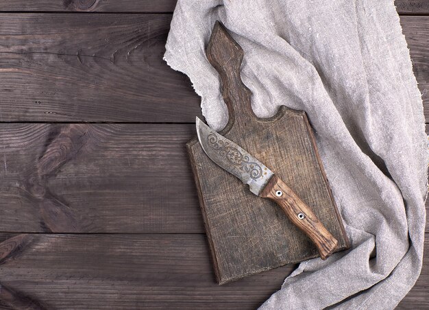 Old wooden kitchen board and vintage knife 