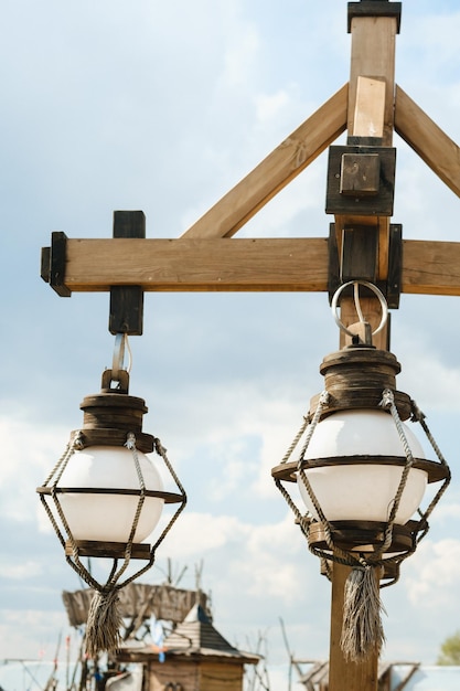 Old wooden lanterns hanging on a wooden pole