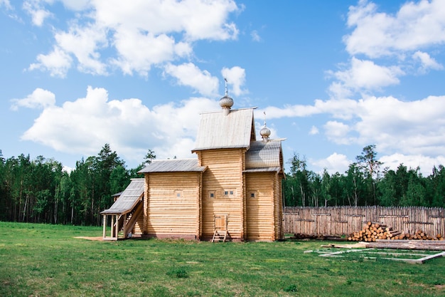 An old wooden Orthodox church in a Russian village on a summer day