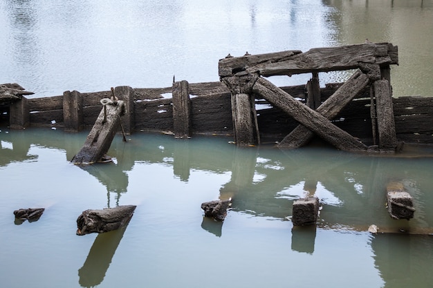 old wooden pier sticks out of the water