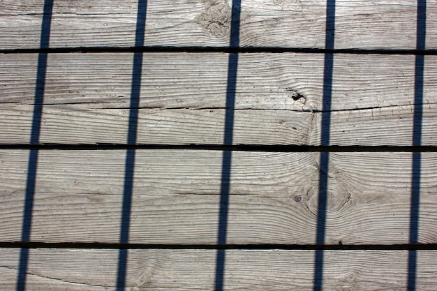 Old wooden planks with grate silhouetteTexture of old dry planks