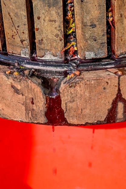 Old wooden press with must inside Pressing grapes for red wine