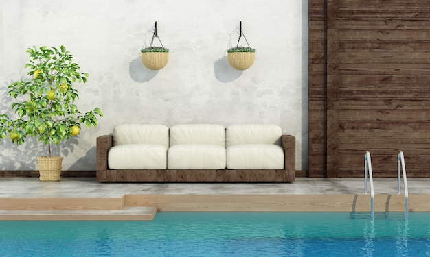 Old wooden sofa on white wall by the pool