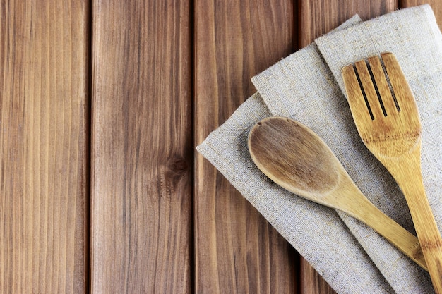 Old wooden spoons on a napkin on a wooden