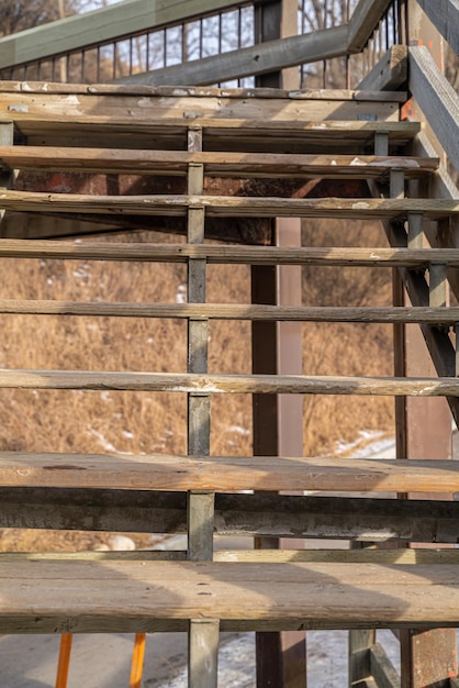 Old Wooden staircase walkway in city with railing