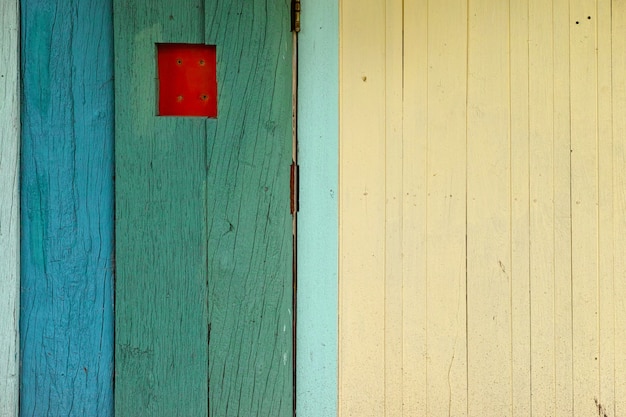 Old wooden surface, green, blue, beautifully decorated on the background of the wall