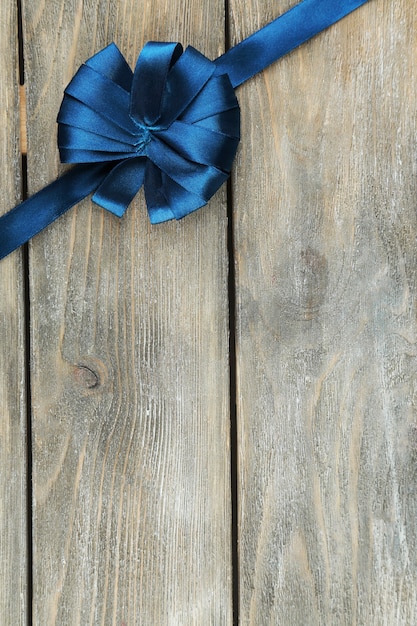 Old wooden table background with beautiful bow