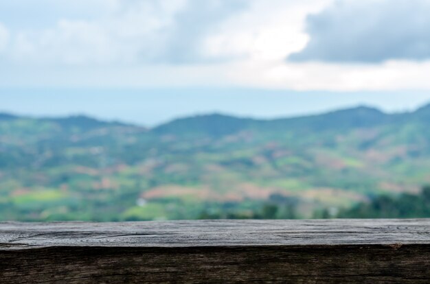 Old wooden table and blur mountain view