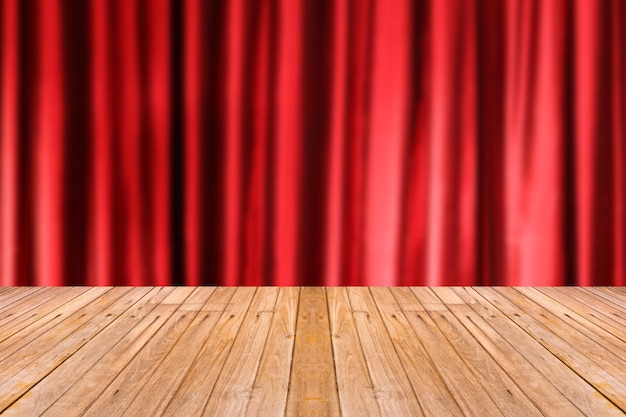 Old wooden table with blur red color curtain background