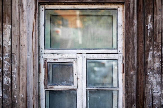 Old wooden twostorey houses with windows in the city of Tomsk