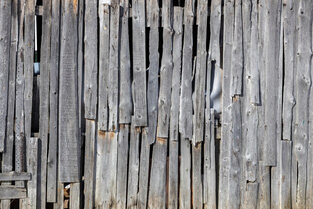 An old wooden wall of planks dilapidated housing