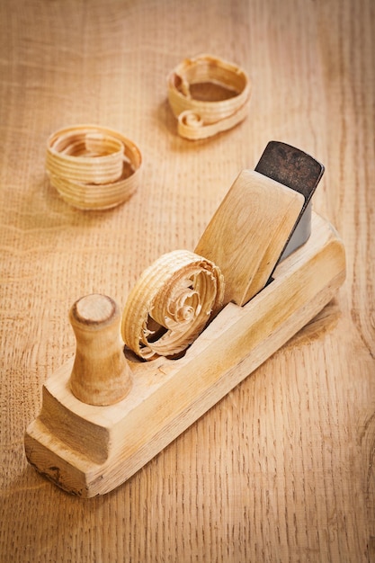 Old woodworking plane with wooden shavings