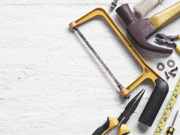 Old working tools on wooden background. 