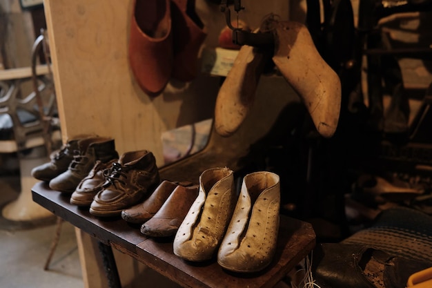 写真 古い靴とパターンと作業道具を持つ靴屋の古いワークショップ