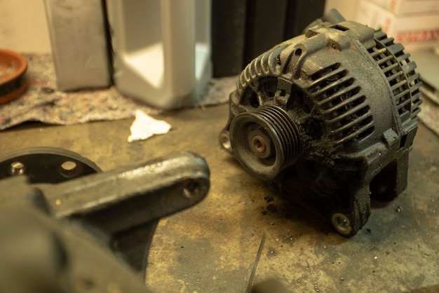 Old worn alternator of the car to be replaced