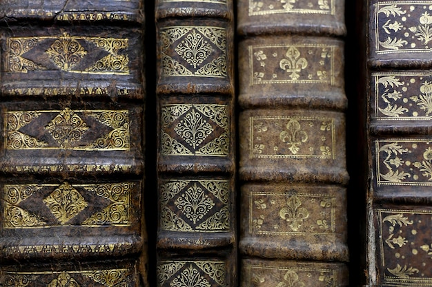 Old worn books on a shelf in the librarys shelfs