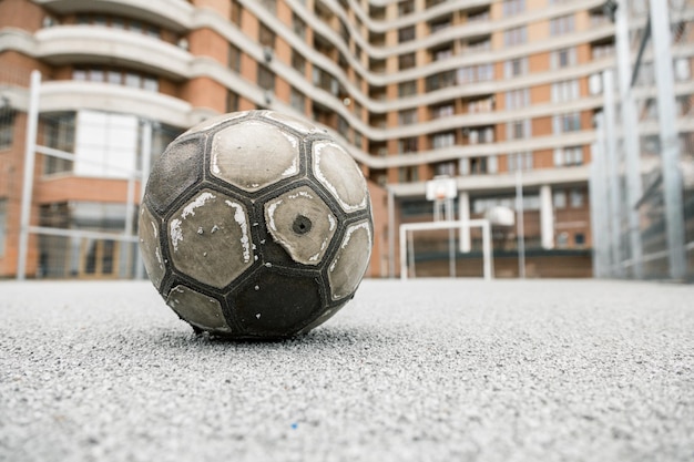 Old worn leather ball  on a playground