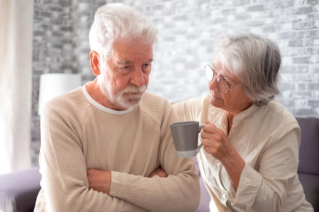 Old worried senior woman comforting her depressed mental ill husband unhappy elderly man at home need medical help Ourmindsmatter