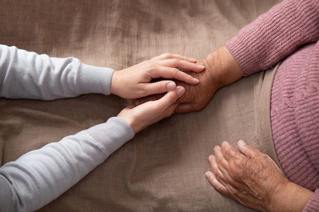 Old and young holding hands old age support help old people