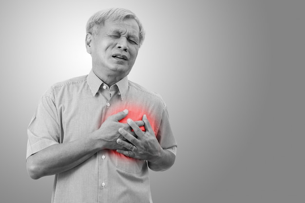 Photo older asian man clutching and having chest pain cause from heart attack.