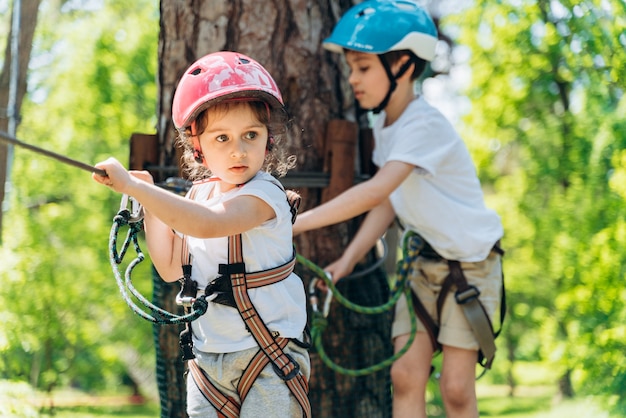 Older brother supports his little sister. He helps her overcome obstacles