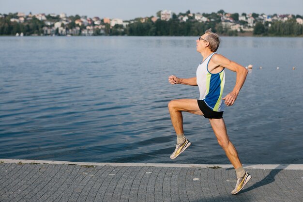 Older man is engaged in running in the fresh air. High quality photo