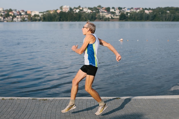 Older man is engaged in running in the fresh air. High quality photo