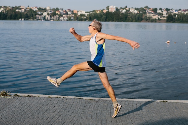 Older man is engaged in running in the fresh air. High quality photo