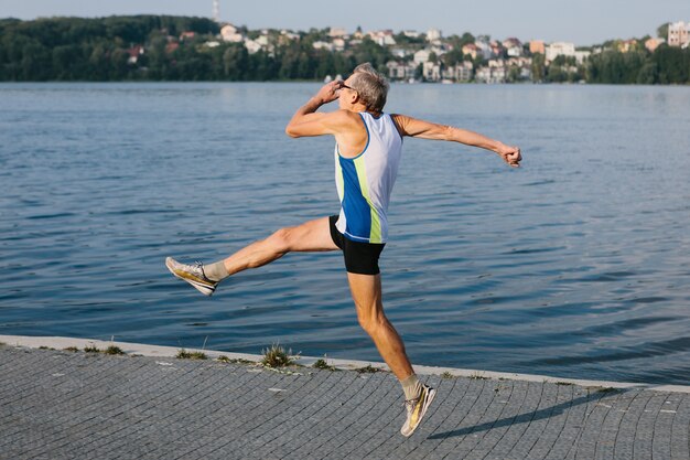 Older man is engaged in running in the fresh air. High quality photo