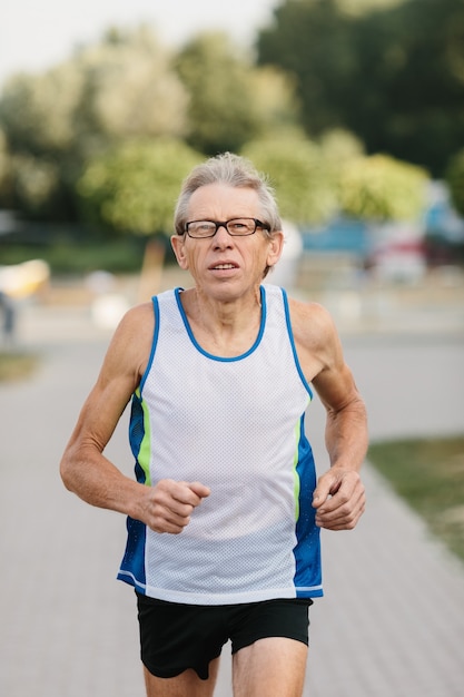 Older man is engaged in running in the fresh air. High quality photo