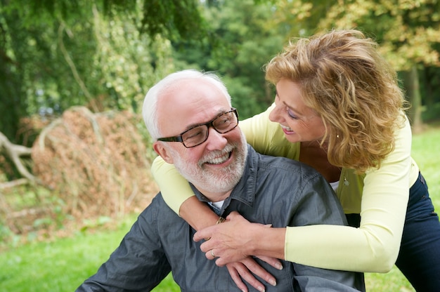 Older man and woman smiling outdoors