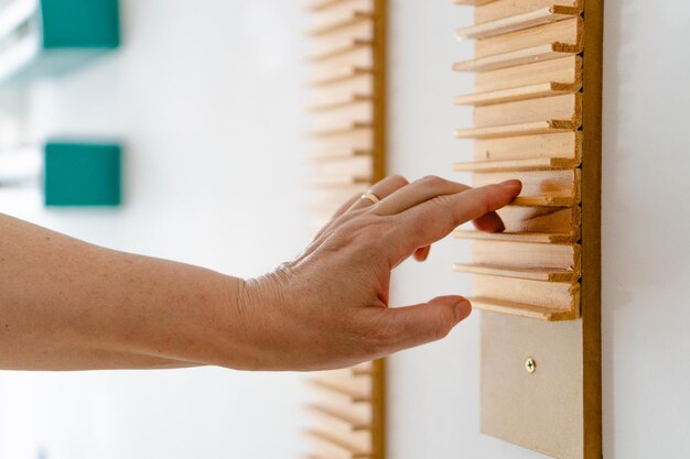 Older woman hand in occupational therapy doing exercises to rehabilitate tendinitis in her shoulder