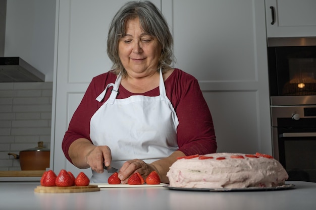 Older woman making a cake