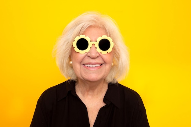 Older woman smiling at camera with funny sunglasses