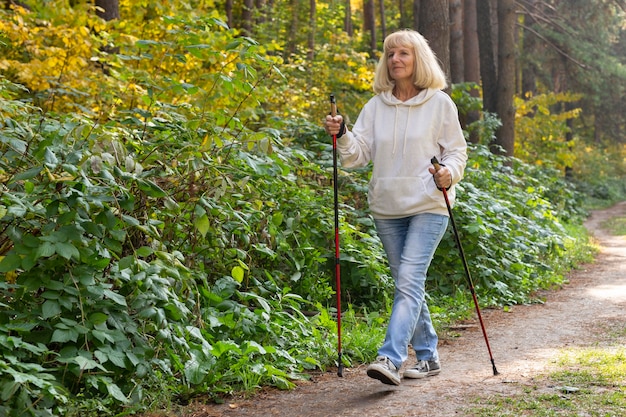 Older woman trekking outside