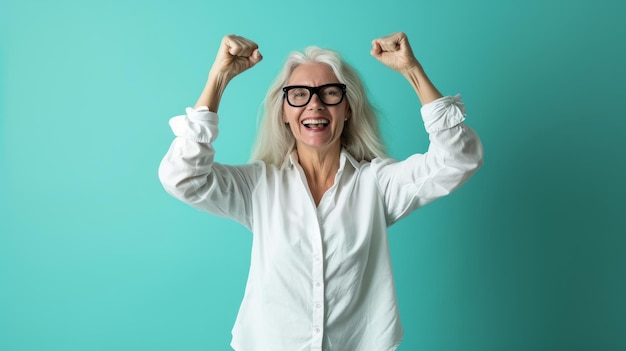 An older woman with glasses and a white shirt is raising her arms