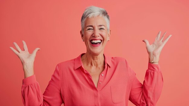 An older woman with her hands in the air and a smile on her face