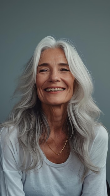 An older woman with long white hair smiling