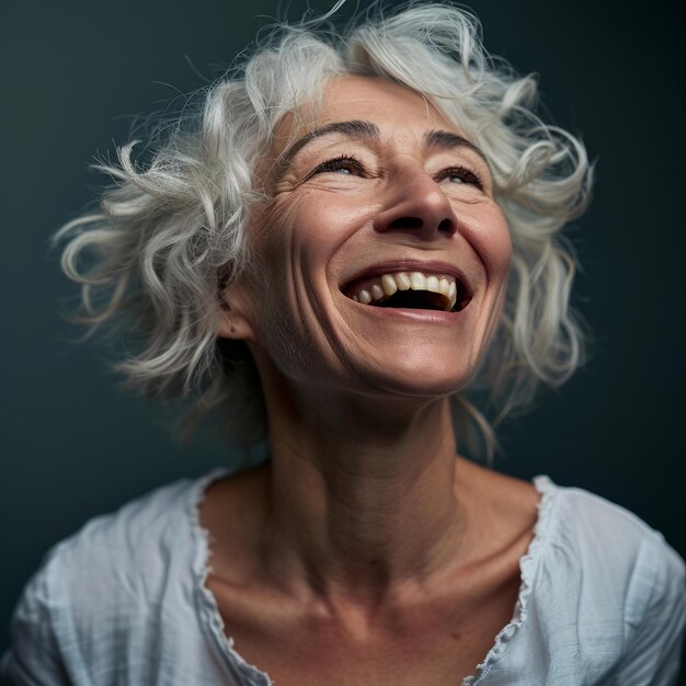 An older woman with white hair laughing