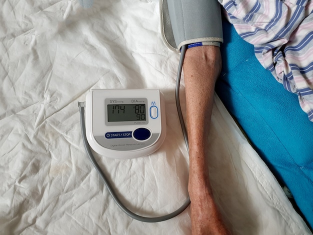 Older women health check blood pressure and heart rate with a digital pressure gauge