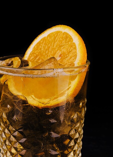 Oldfashioned cocktail with ice and orange slice