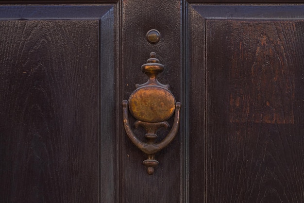 Oldfashioned metal handleDoorknocker on allwood door