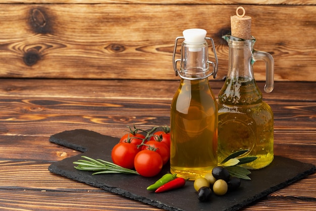 Olijfolie olijven en tomaten op houten achtergrond